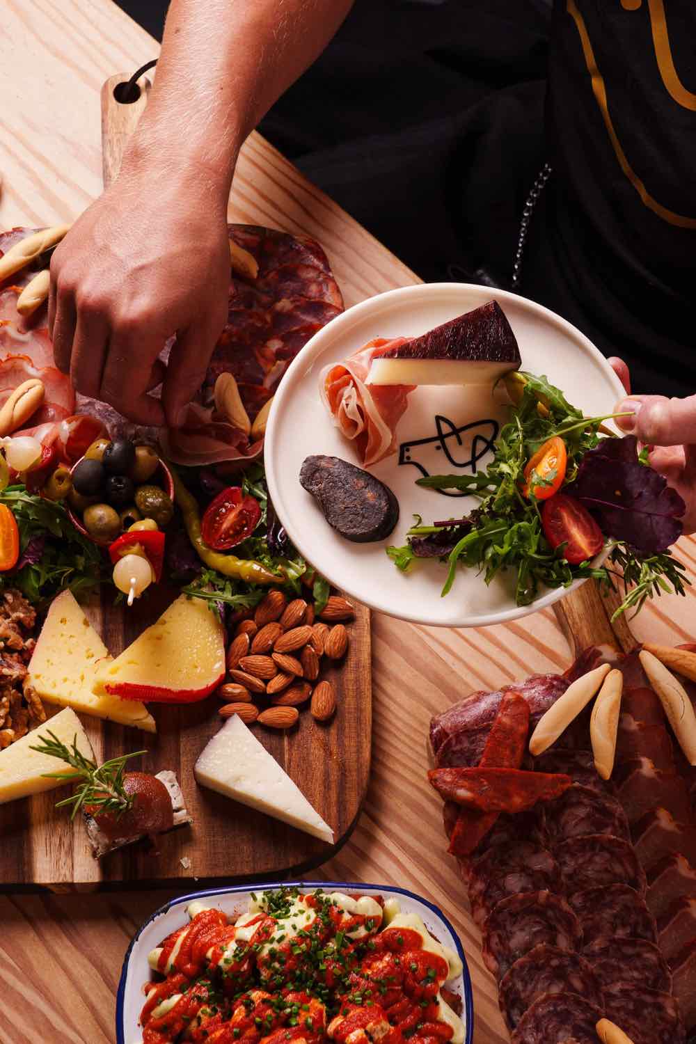 A generous spread of Spanish charcuterie and tapas for a group at Piggs