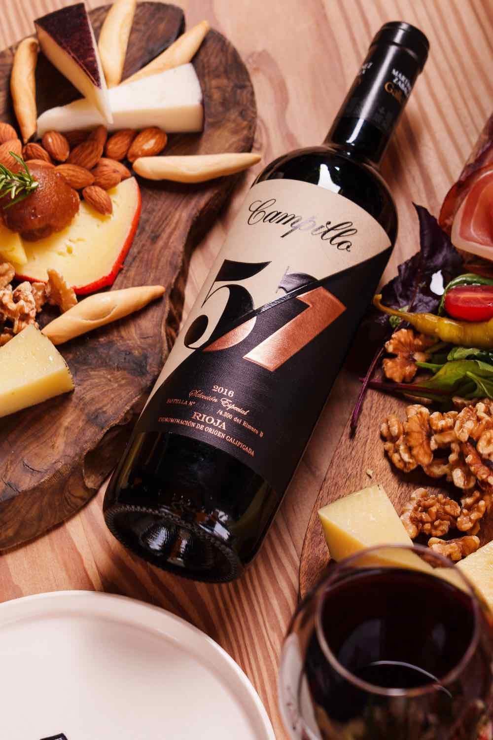 A cheese board and a bottle of Spanish wine on an oak table at Piggs