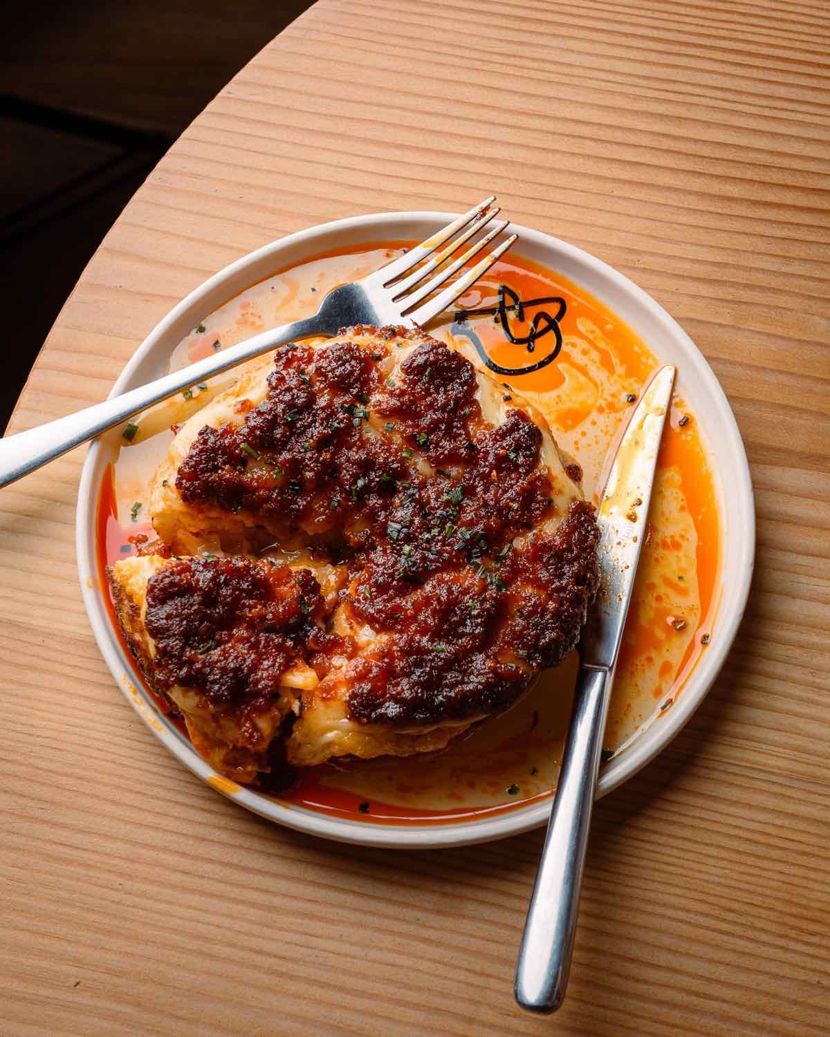 A plated Spanish dish on a Piggs enamel plate, seen from above