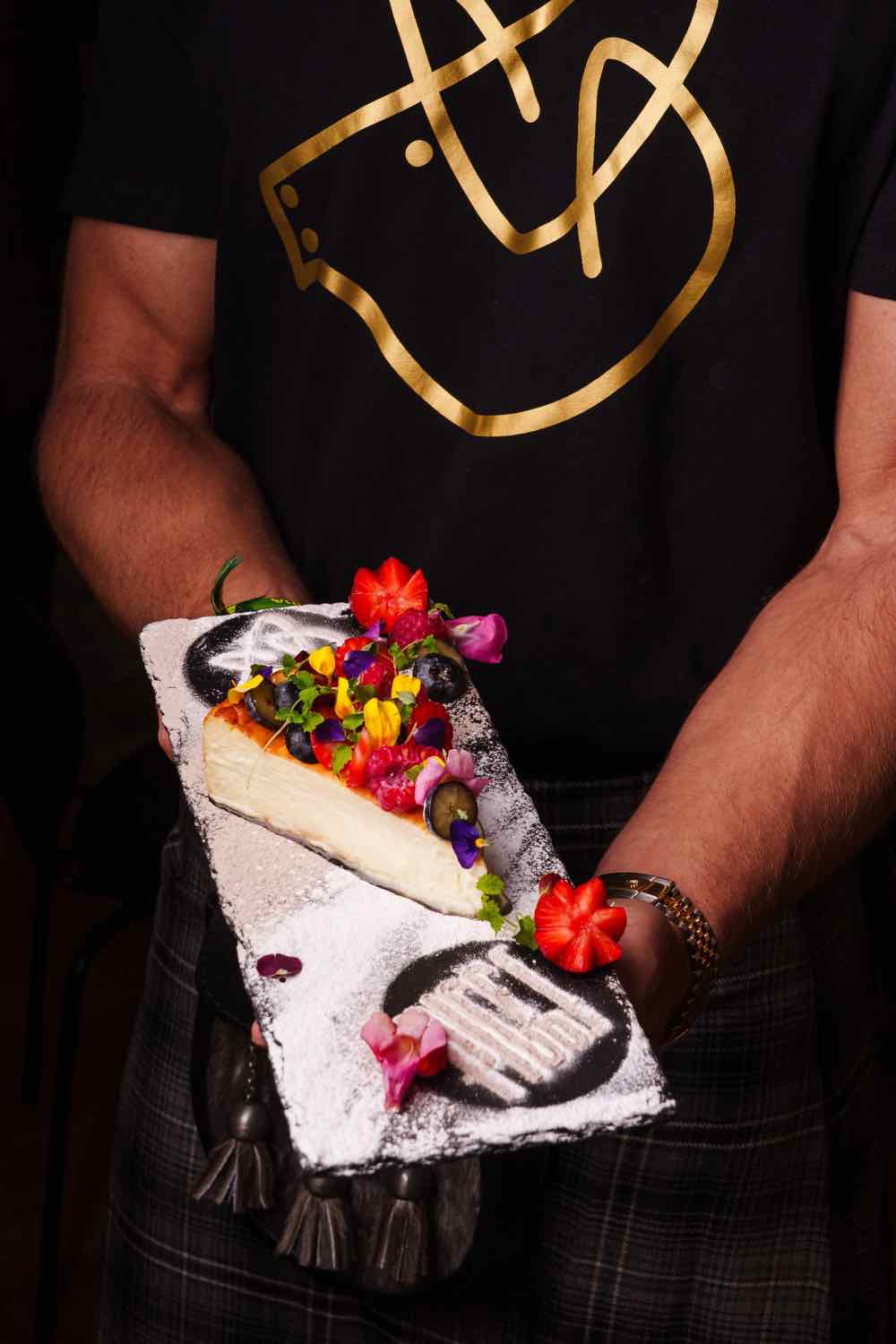 Piggs staff in branded t-shirts carrying a dessert board